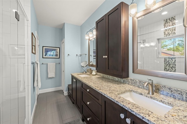 2623 57th St S, Gulfport, FL 33707 - full bath featuring a sink, a tile shower, double vanity, and baseboards