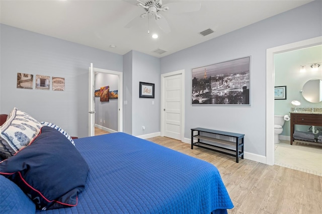 2623 57th St S, Gulfport, FL 33707 - bedroom with wood finished floors, baseboards, visible vents, and connected bathroom
