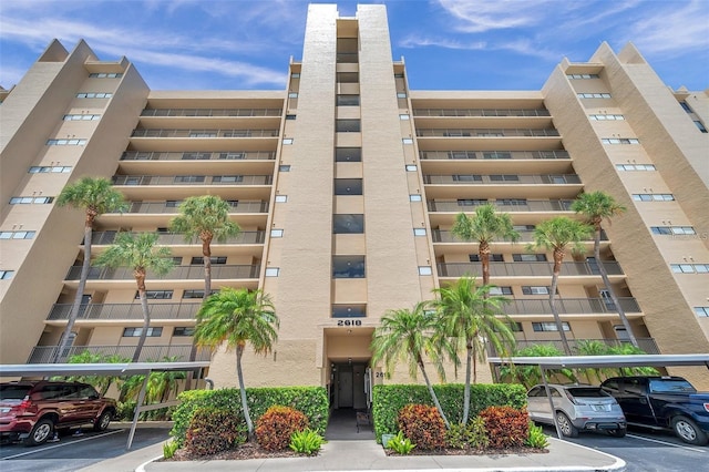 view of building exterior with covered parking