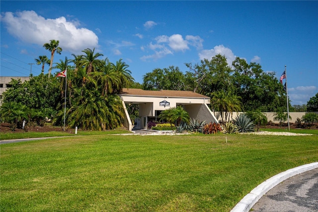 view of front of property featuring stucco siding, fence, and a front lawn