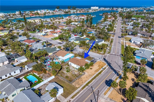 birds eye view of property with a water view and a residential view