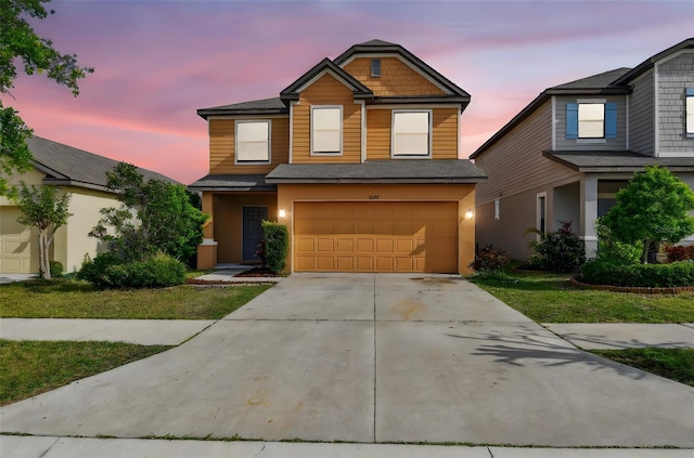 view of front of house featuring an attached garage, roof with shingles, and concrete driveway