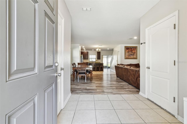 entrance foyer featuring light tile patterned floors, baseboards, visible vents, and recessed lighting