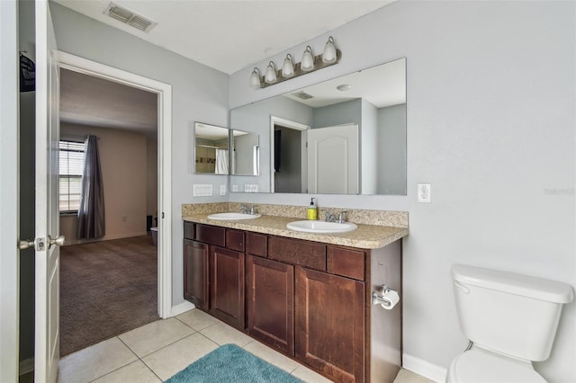 full bathroom with a sink, visible vents, tile patterned floors, and toilet