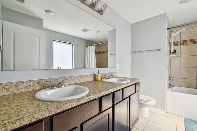 bathroom featuring a sink, visible vents, tile patterned floors, and toilet