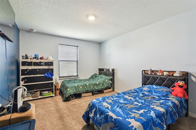 bedroom with a textured ceiling, carpet flooring, and baseboards