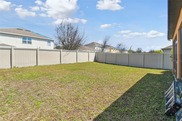 view of yard with a fenced backyard