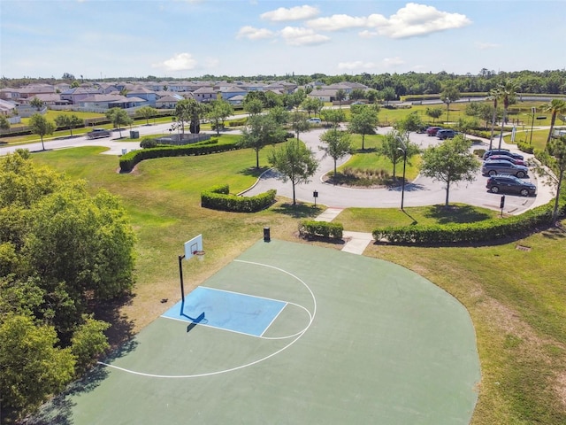 view of sport court with a residential view, community basketball court, and a lawn