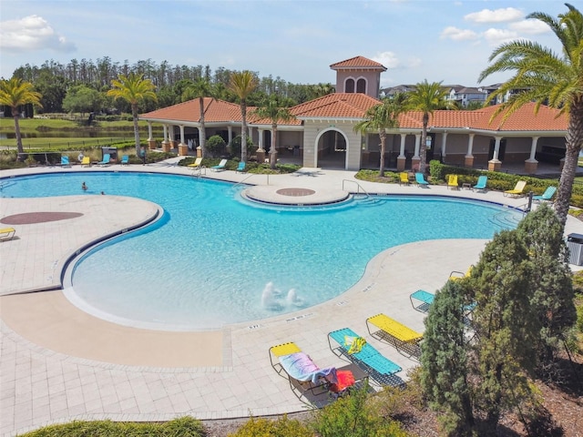 community pool featuring a patio area and fence