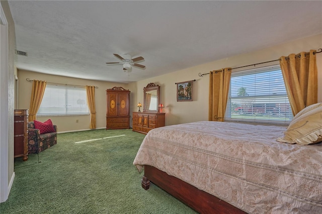 6589 Banyan Dr, Indian Lake Estates, FL 33855 - carpeted bedroom featuring visible vents, baseboards, and a ceiling fan