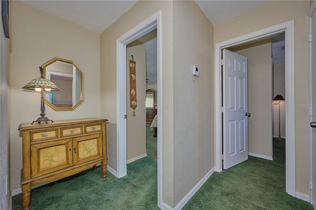 6589 Banyan Dr, Indian Lake Estates, FL 33855 - corridor featuring dark carpet and baseboards