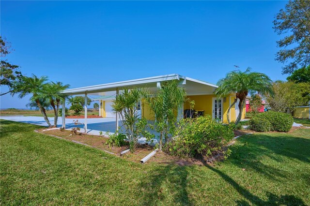 6589 Banyan Dr, Indian Lake Estates, FL 33855 - exterior space featuring a yard, stucco siding, and an attached carport