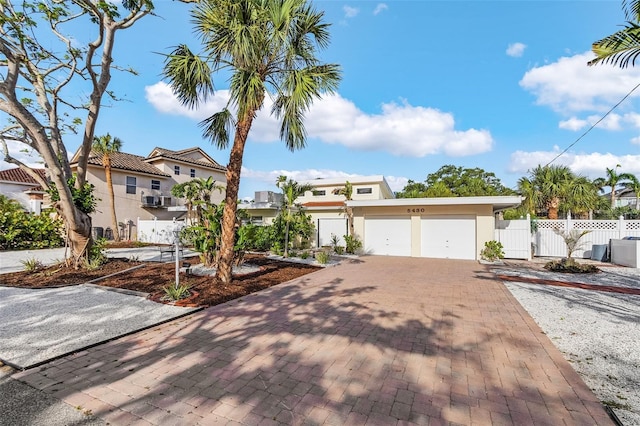 5430 Avenida Del Mare, Sarasota, FL 34242 - view of front of property featuring stucco siding, decorative driveway, and a garage