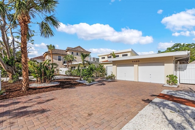 5430 Avenida Del Mare, Sarasota, FL 34242 - view of front facade featuring stucco siding, decorative driveway, and an attached garage