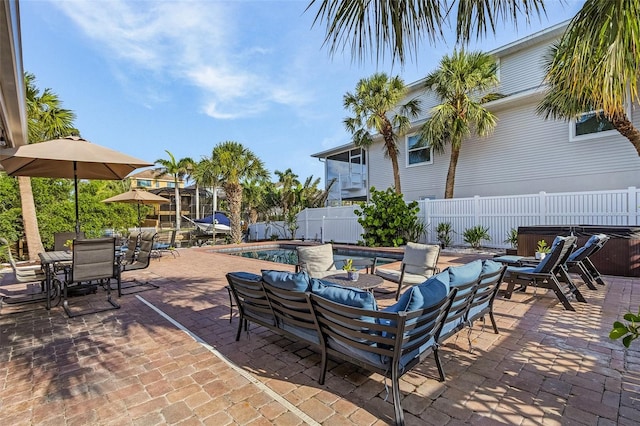 5430 Avenida Del Mare, Sarasota, FL 34242 - fenced backyard featuring a hot tub, a patio area, outdoor dining area, and an outdoor hangout area