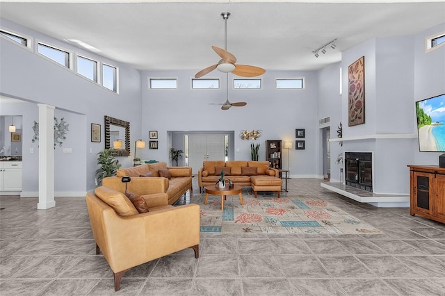 5430 Avenida Del Mare, Sarasota, FL 34242 - living area with ceiling fan, a high ceiling, a glass covered fireplace, and rail lighting