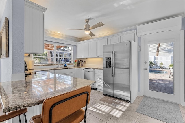 5430 Avenida Del Mare, Sarasota, FL 34242 - kitchen featuring stainless steel appliances, a peninsula, ornamental molding, ceiling fan, and a breakfast bar