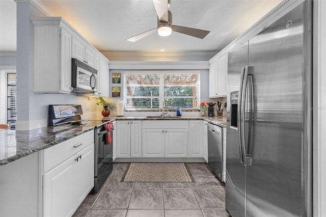 5430 Avenida Del Mare, Sarasota, FL 34242 - kitchen featuring appliances with stainless steel finishes, ornamental molding, ceiling fan, white cabinetry, and dark stone counters