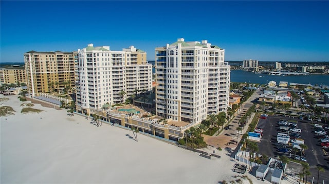 view of apartment building / complex featuring a water view and a city view