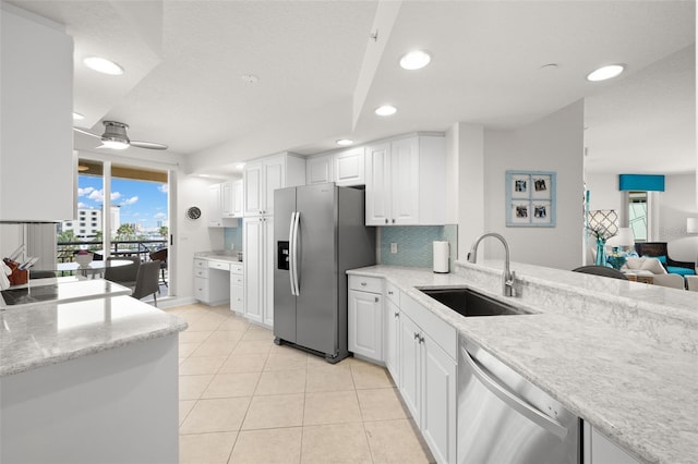 kitchen with stainless steel appliances, a sink, recessed lighting, white cabinetry, and ceiling fan