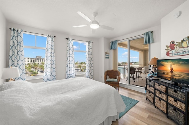 bedroom with access to outside, light wood-style floors, and ceiling fan