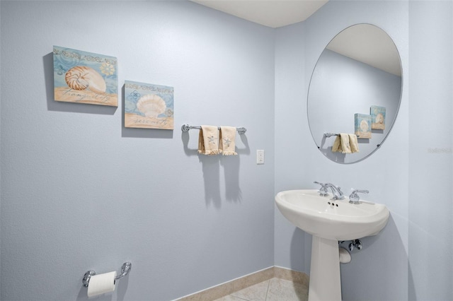 bathroom with baseboards and tile patterned floors