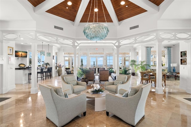 community lobby featuring wood ceiling, beamed ceiling, recessed lighting, a towering ceiling, and ornamental molding