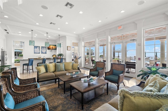 living area with crown molding and recessed lighting