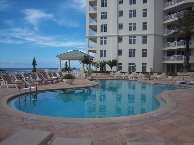 community pool featuring a gazebo and a patio area