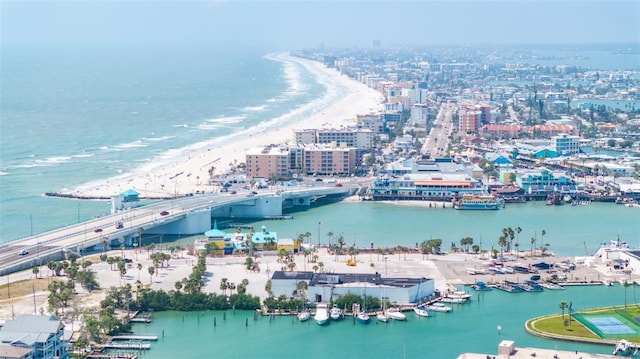 drone / aerial view with a city view, a view of the beach, and a water view