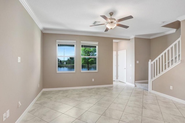 empty room with stairs, a ceiling fan, light tile patterned floors, baseboards, and ornamental molding