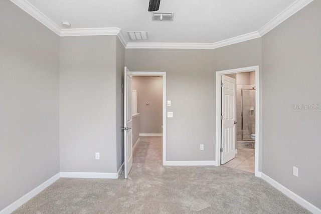unfurnished bedroom featuring baseboards, carpet flooring, and visible vents