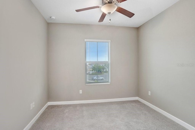 unfurnished room featuring a ceiling fan, carpet floors, and baseboards