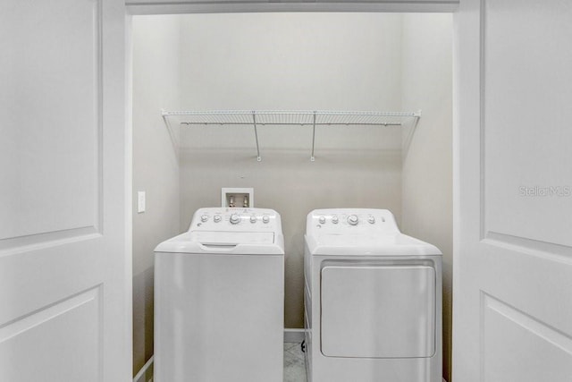 washroom featuring laundry area and separate washer and dryer