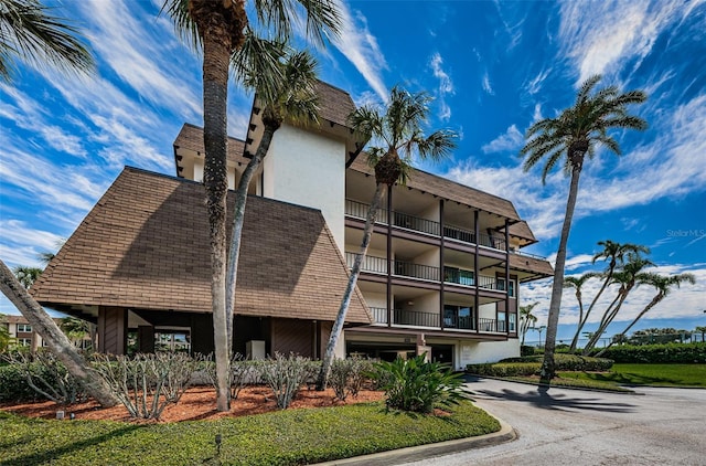 3021 Countryside Blvd Unit 45A, Clearwater, FL 33761 - view of building exterior with a garage and aphalt driveway