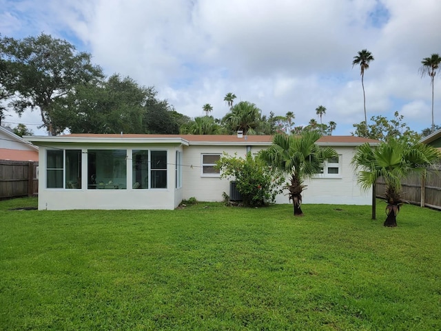 3919 Harrisburg St NE, Saint Petersburg, FL 33703 - rear view of house featuring a yard, fence, and central air condition unit