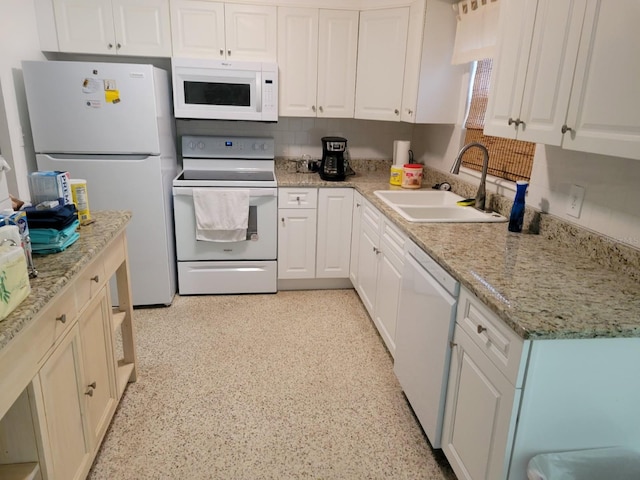 3919 Harrisburg St NE, Saint Petersburg, FL 33703 - kitchen featuring decorative backsplash, a sink, white appliances, and white cabinets