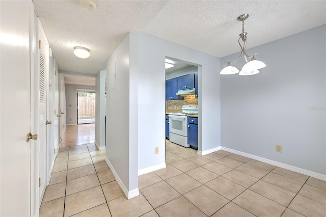 1424 Highland Ridge Cir, Brandon, FL 33510 - corridor with light tile patterned floors, baseboards, and a textured ceiling