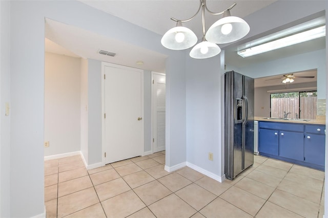 1424 Highland Ridge Cir, Brandon, FL 33510 - kitchen with visible vents, blue cabinetry, black fridge with ice dispenser, and light tile patterned floors