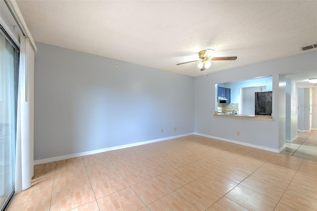 1424 Highland Ridge Cir, Brandon, FL 33510 - empty room with a textured ceiling, baseboards, a ceiling fan, and visible vents