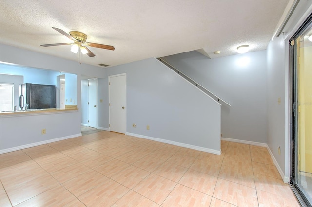 1424 Highland Ridge Cir, Brandon, FL 33510 - unfurnished living room featuring visible vents, a textured ceiling, baseboards, and ceiling fan