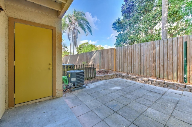 1424 Highland Ridge Cir, Brandon, FL 33510 - view of patio featuring central air condition unit and a fenced backyard