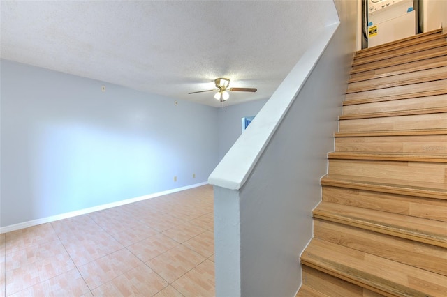 1424 Highland Ridge Cir, Brandon, FL 33510 - stairs featuring ceiling fan, tile patterned flooring, baseboards, and a textured ceiling