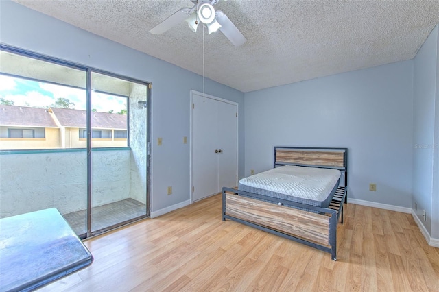1424 Highland Ridge Cir, Brandon, FL 33510 - bedroom with baseboards, access to outside, wood finished floors, and a textured ceiling