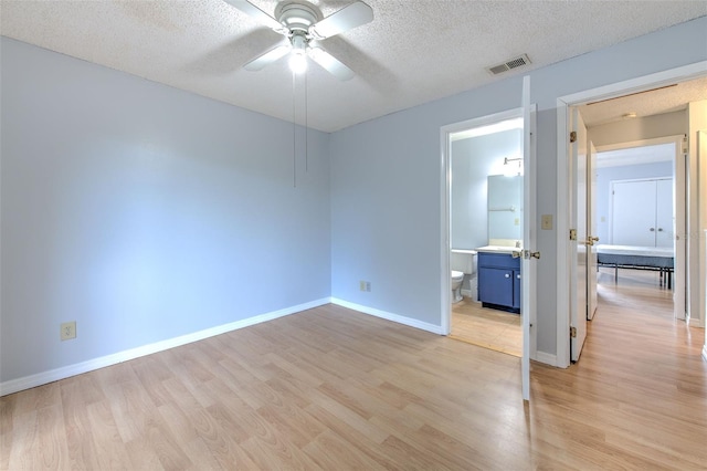 1424 Highland Ridge Cir, Brandon, FL 33510 - unfurnished room with light wood-type flooring, ceiling fan, visible vents, and a textured ceiling