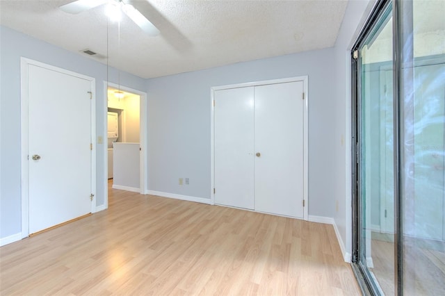 1424 Highland Ridge Cir, Brandon, FL 33510 - unfurnished bedroom featuring baseboards, a textured ceiling, a ceiling fan, visible vents, and light wood finished floors