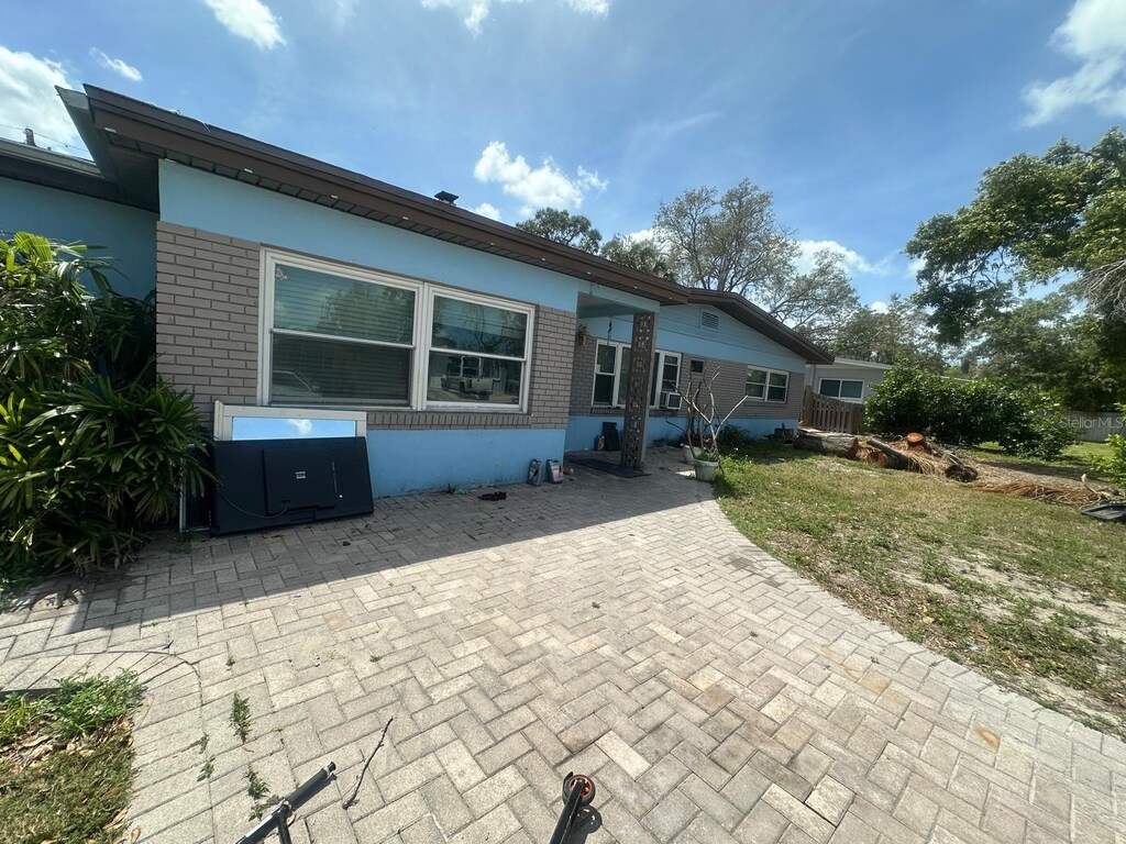 rear view of house featuring brick siding