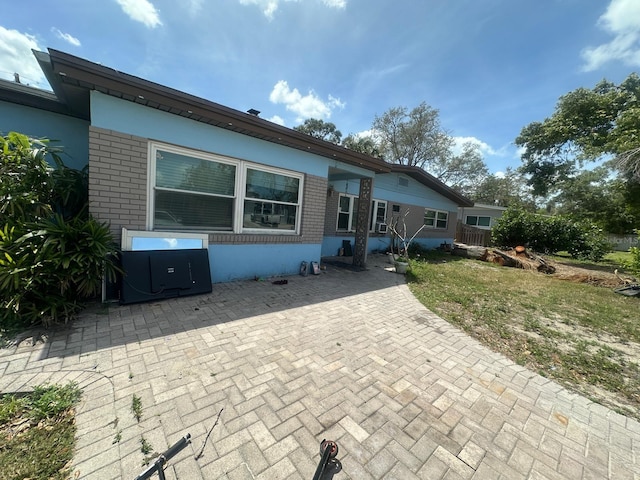 rear view of house featuring brick siding
