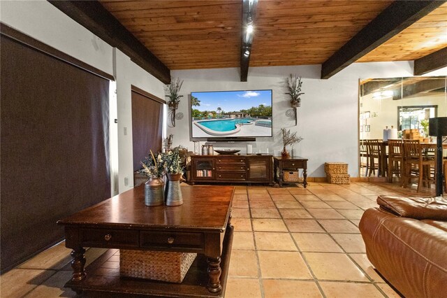 19440 NE 26th Ave Unit 53B, Miami, FL 33180 - living room featuring beam ceiling, wooden ceiling, light tile patterned floors, and baseboards