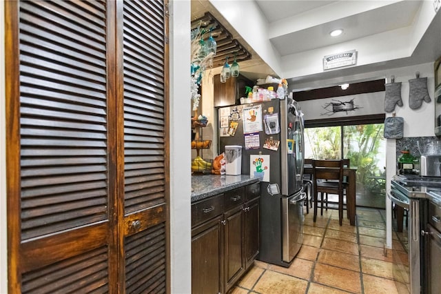19440 NE 26th Ave Unit 53B, Miami, FL 33180 - kitchen with stainless steel appliances, dark brown cabinets, stone tile flooring, and recessed lighting